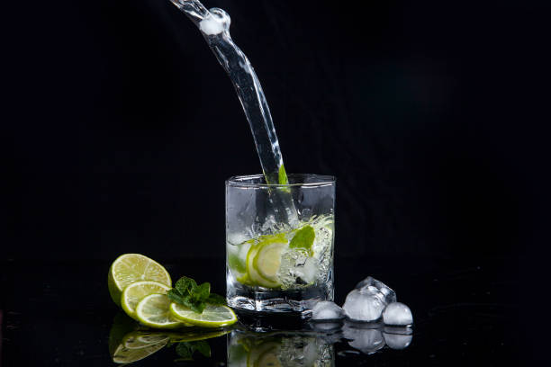 istock Summer cocktail mojito with splash on black background. 1152389105