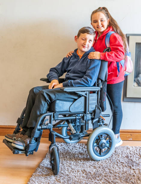 istock Young carer with boy in wheelchair 1152390488