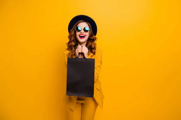 Photo of Close up photo beautiful she her lady very glad black friday laughter carry packs perfect look buy buyer birthday sale discount wear specs formal-wear costume suit isolated yellow bright background