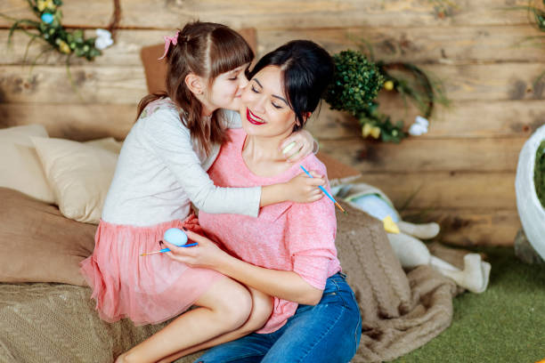 istock Daughter kisses mom Happy Easter 1152394238
