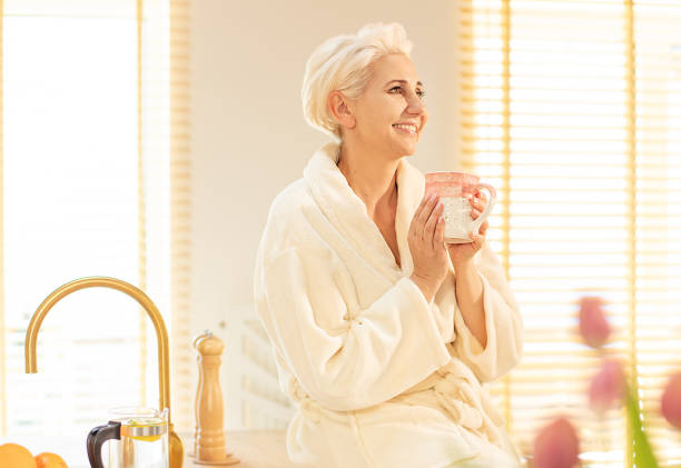 istock Smiling woman relaxing with coffee. 1152394752