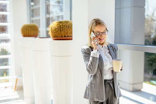 Smiling business woman talking on phone
