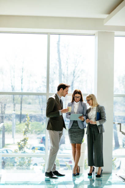 istock Business people using digital tablet in the lobby 1152395790
