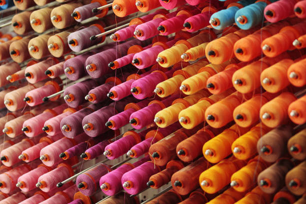 Sewing thread background Multicolor sewing thread. Many colored thread spools textile factory stock pictures, royalty-free photos & images