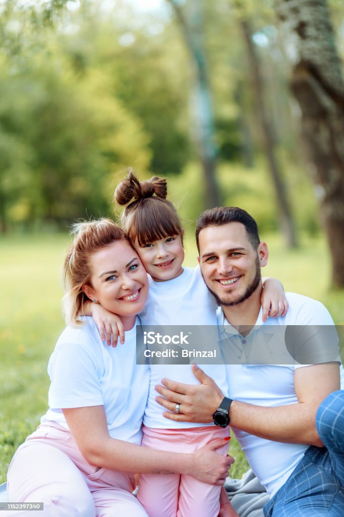 Happiness and harmony in family life. Happy family concept. Young mother and father with their daughter in the park. Happy family. Carefree, happylife. Happiness and harmony in family life. Happy family concept. Young mother and father with their daughter in the park. Child Stock Photo