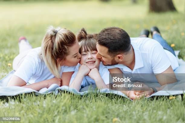 Happiness And Harmony In Family Life Happy Family Concept Young Mother And Father With Their Daughter In The Park Happy Family Carefree Happylife Stock Photo - Download Image Now