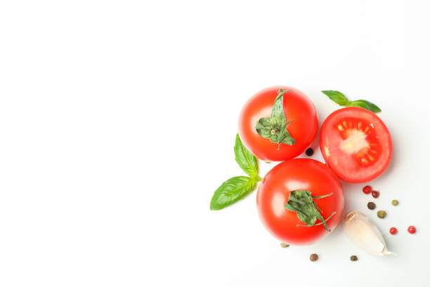 istock Fresh cherry tomatoes with basil, pepper and garlic on white background, space for text and top view. Ripe vegetables 1152399015