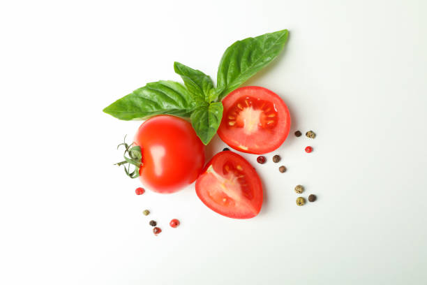 istock Fresh cherry tomatoes with basil and spices on white background, space for text and top view. Ripe vegetables 1152399140