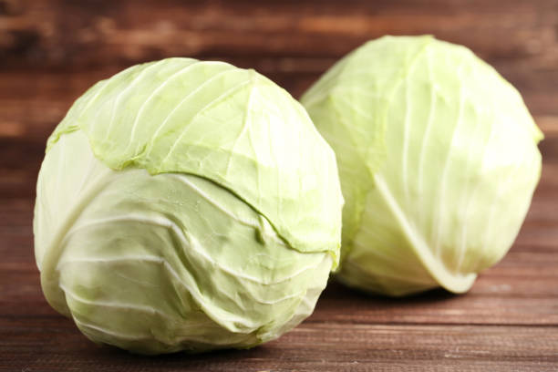 istock Ripe cabbage on brown wooden table 1152401720