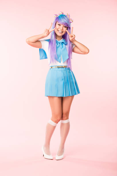 Full length view of cheerful asian otaku girl showing peace signs on pink Full length view of cheerful asian otaku girl showing peace signs on pink cosplay stock pictures, royalty-free photos & images