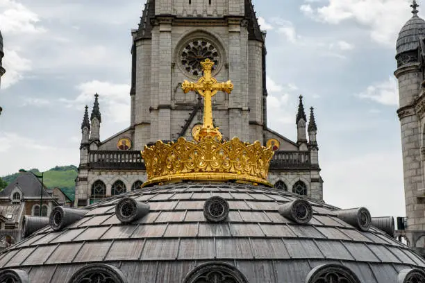 Photo of The gilded crown of the Lourdes Basilica. Pilgrimage to Lourdes.