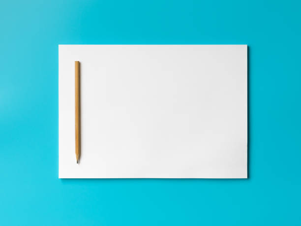 istock A stack of blank sheets of paper and a pencil on a blue background. Creative crisis or the beginning of a new novel. 1152408971