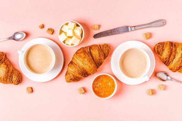 istock Coffee and croissants on pastel background 1152410940