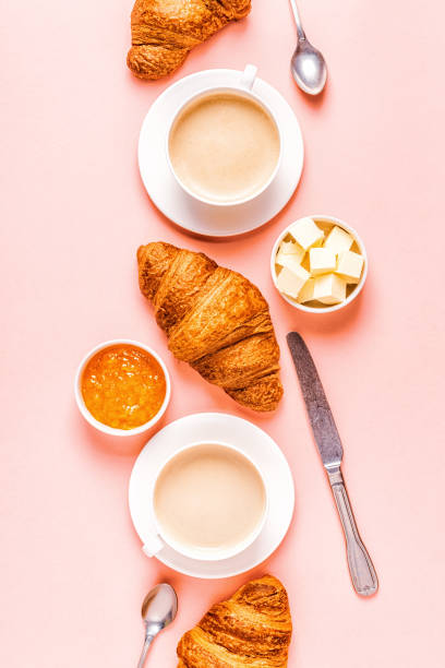 istock Coffee and croissants on pastel background 1152410979