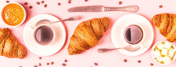 istock Coffee and croissants on pastel background 1152411108