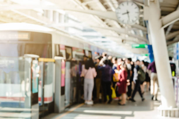 Blurry of people getting on and getting out electric skytrain with automatic gateway, railroad transportation for passenger in city, traveler and urban lifestyle.