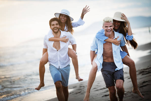 istock Friends having fun on the beach under sunset sunlight. 1152412805