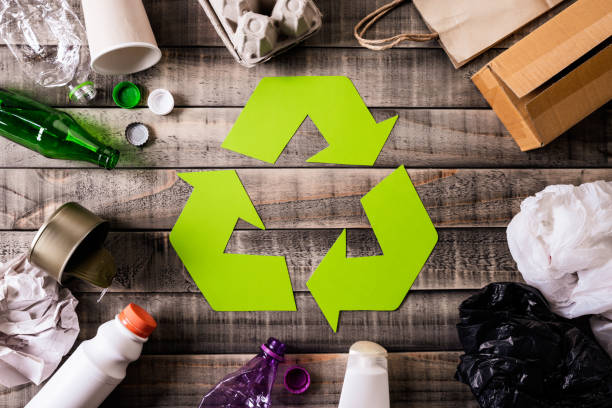 istock Top view of Different garbage materials with recycling symbol on table background. Recycle, environment and Eco concept 1152412936