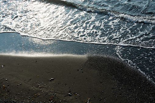 Waves rushing to the sandy beach