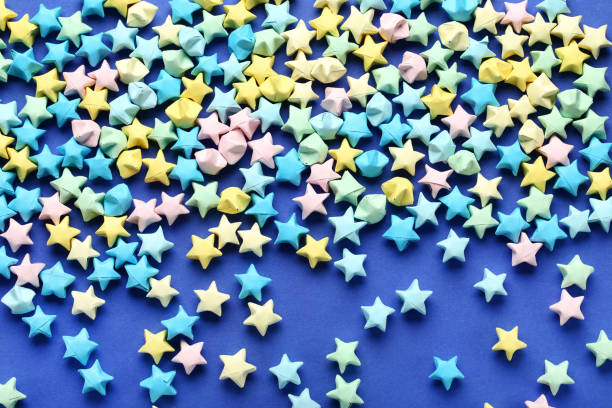 istock Colorful paper stars on blue background 1152417032