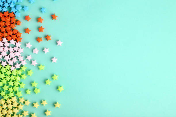 istock Colorful paper stars on blue background 1152417043