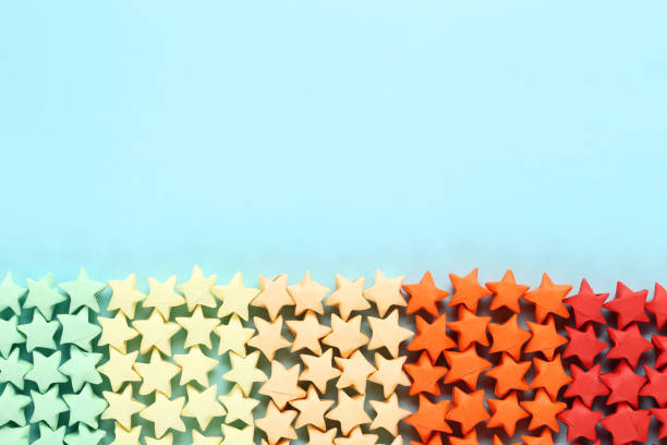istock Colorful paper stars on blue background 1152417071