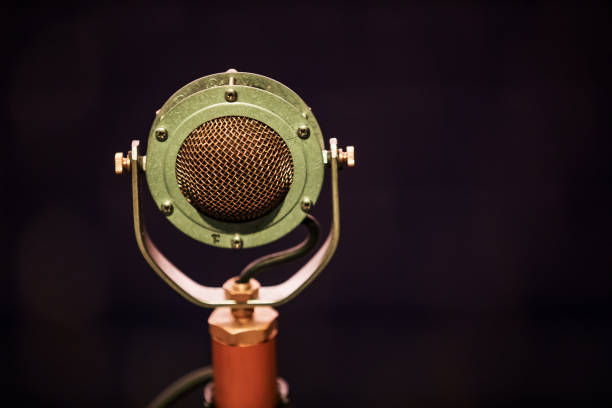 istock Microphone on stage against a background of auditorium. 1152420856