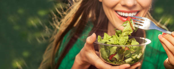 istock Beautiful woman eating salad 1152420922