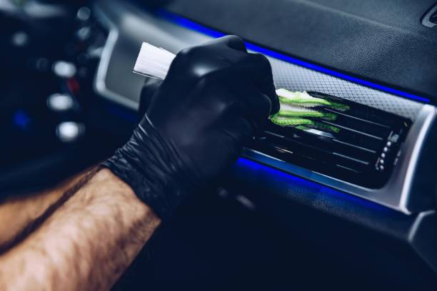 istock Man worker in car wash cleaning car air vent 1152422132