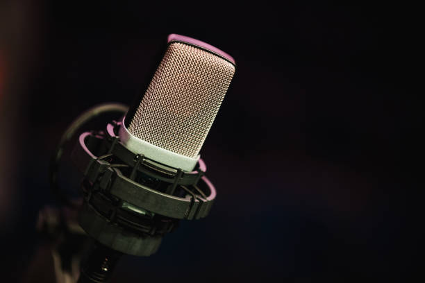 istock Microphone on stage against a background of auditorium. 1152422214