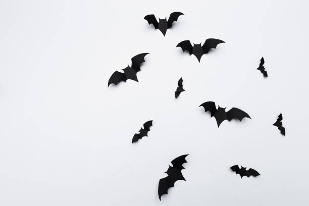 istock halloween and decoration concept - paper bats flying 1152422593