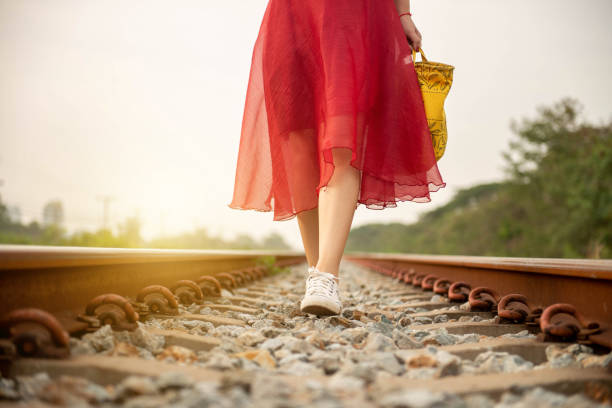 girl walking on railway alone, sadly walikng with dollmate