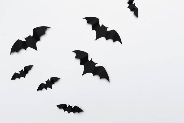 istock halloween and decoration concept - paper bats flying 1152423423