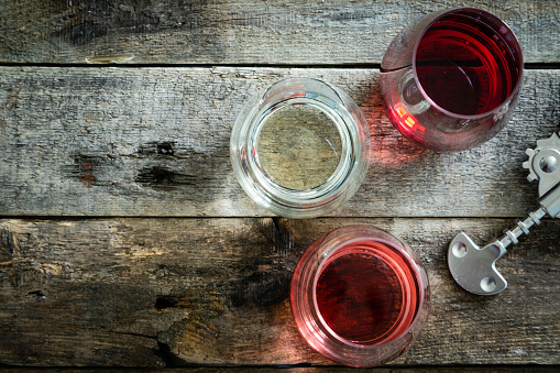 WIne tasting concept - red, rose and white wine in glasses on wood background