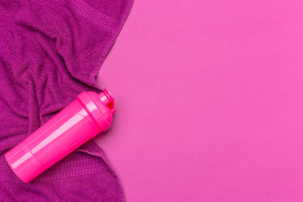 istock Pink plastic protein shaker cup on pink background 1152428238
