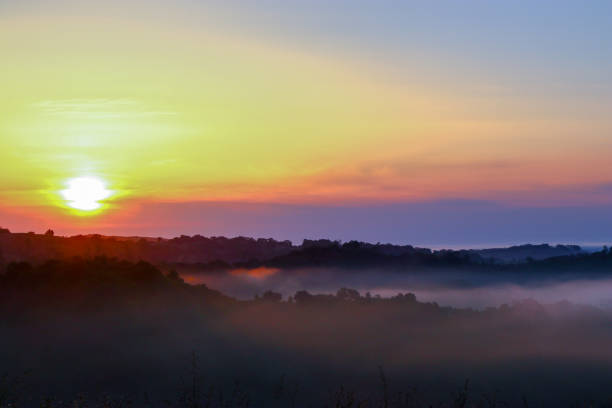 istock Sunrise and fog over hills 1152428277