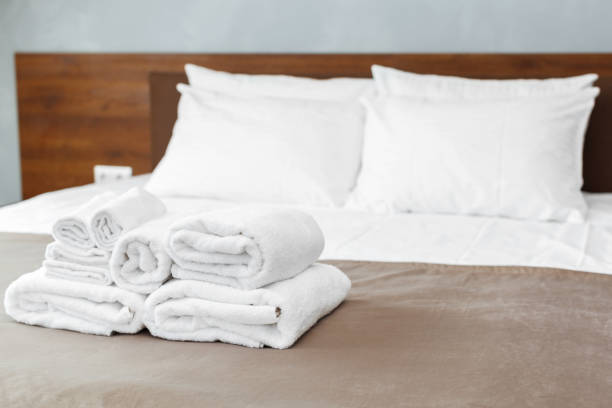 istock White towel on bed in guest room for hotel customer 1152428517