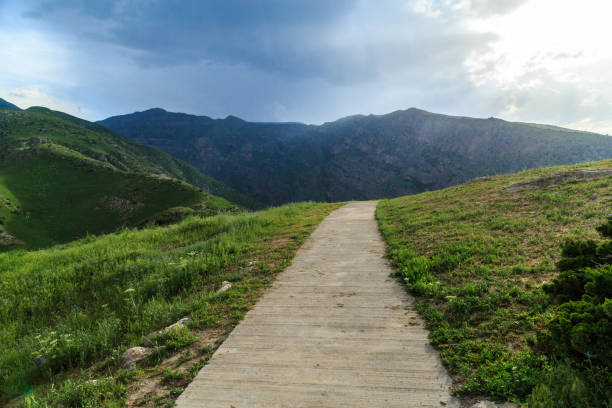 istock Narrow walking path in the mountains leading into the clouds 1152428596