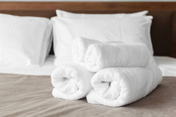 istock White towel on bed in guest room for hotel customer 1152428670