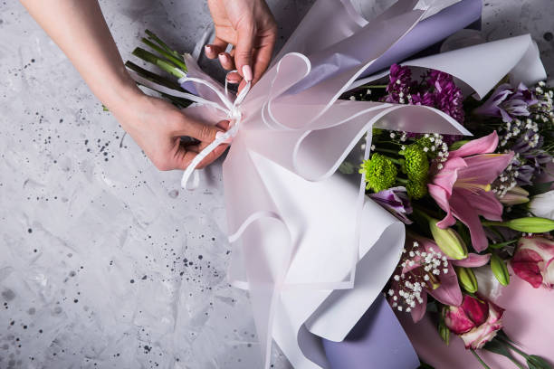 istock Florist's work in the process of creating a bouquet with lilies in the workplace 1152429961