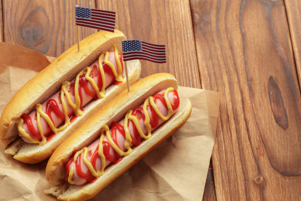 istock Hot dogs on wooden background 1152431894