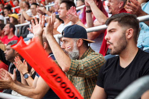istock Ecstatic fans on the stadium cheering 1152432299