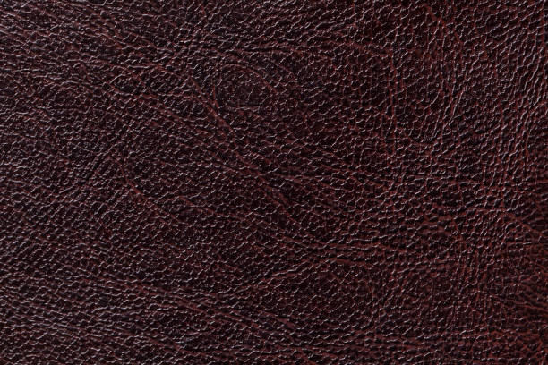 istock lacquered black leather texture background, closeup. Dark brown backdrop 1152433082