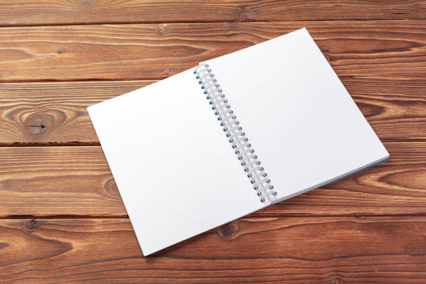 istock Office desk table top view. Notepad with blank pages on wooden table 1152433360