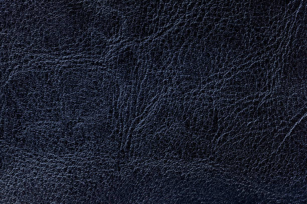 istock Dark navy blue leather texture background, closeup. Denim cracked backdrop from wrinkle skin 1152433623
