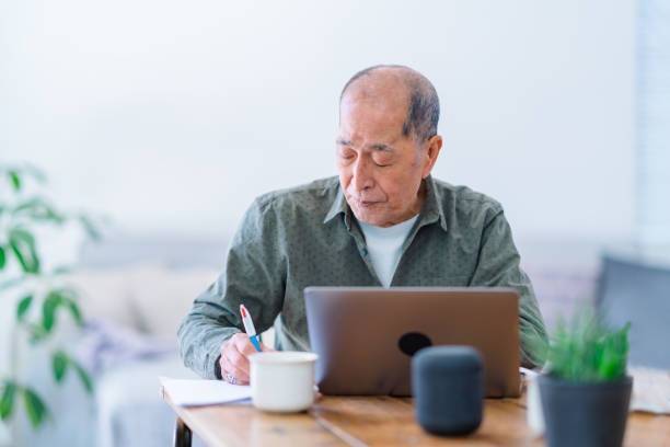 istock Active senior man working on laptop at home 1152434810