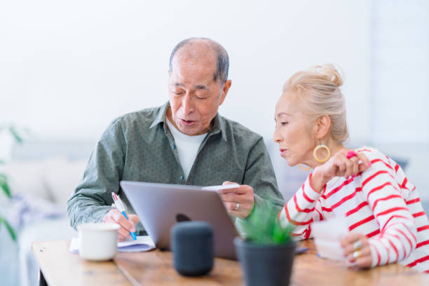 istock Happy senior couple using laptop at home 1152434852