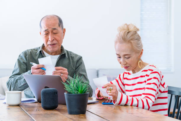 istock Happy senior couple using laptop at home 1152434875