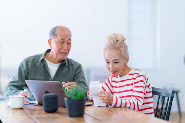 istock Happy senior couple using laptop at home 1152434897