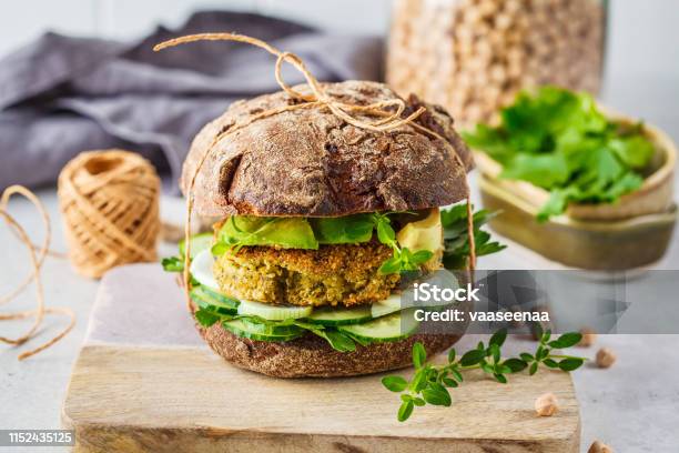 Vegan Sandwich With Chickpea Patty Avocado Cucumber And Greens In Rye Bread Stock Photo - Download Image Now